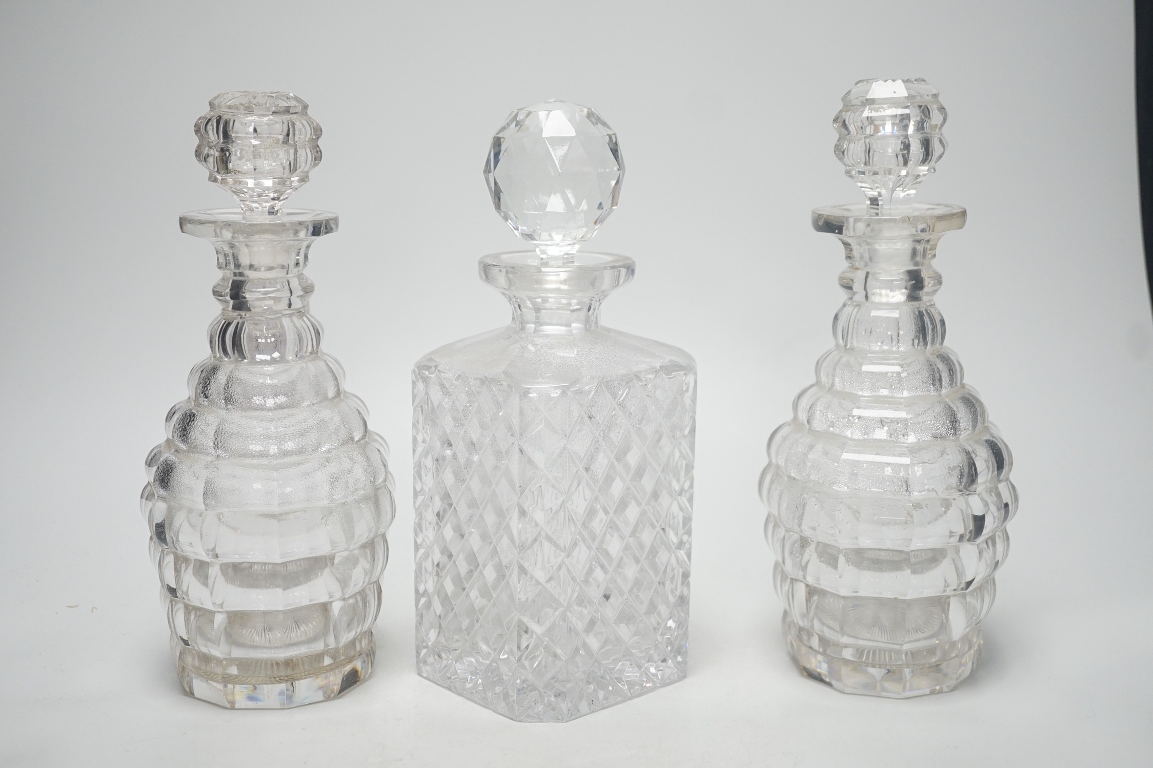 A pair of Victorian cut glass decanters and stoppers and one other, tallest 26cm